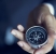 Businessman with a compass holding in hand, color tone film look