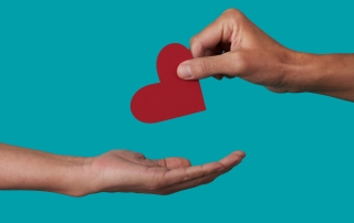 person giving a heart to another person